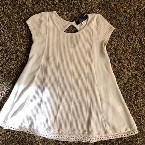 Short sleeve flaired cream colored T-shirt.